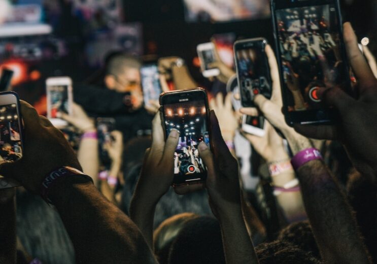 shallow focus photography of crowd taking video